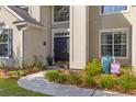 Beautiful home's front door and walkway surrounded by plants and fresh mulch at 6242 Fieldstone Cir, Charleston, SC 29414
