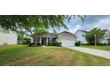 Well-maintained home with a lush green lawn and classic architectural details at 7019 Lanier St, Hanahan, SC 29410