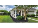 Cozy front porch with white columns, comfortable seating, and a relaxing hammock at 7019 Lanier St, Hanahan, SC 29410
