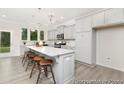 Bright, open kitchen featuring gray cabinets, a large island with seating, and stainless steel appliances at 714 N Hickory St # 13, Summerville, SC 29483