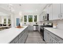 Modern kitchen with a large island, stainless steel appliances, and stylish gray cabinets at 714 N Hickory St # 13, Summerville, SC 29483