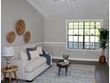 Bright living room featuring a stylish couch, decorative wall art, and an inviting area rug at 7774 Ginger Ln, North Charleston, SC 29420