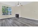 Spacious living room with high ceilings, a fireplace, and large windows for ample natural light at 7869 High Maple Cir, North Charleston, SC 29418