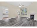 Bright, open living room with fireplace, large windows, and views of the kitchen and dining areas at 7869 High Maple Cir, North Charleston, SC 29418