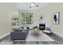 Comfortable living room with gray sofa, accent chairs, and fireplace, creating an inviting and stylish space at 7869 High Maple Cir, North Charleston, SC 29418