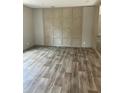 Spacious living room featuring light wood-look vinyl flooring and a light wood accent wall at 852 Lawyer Ln, Cross, SC 29436