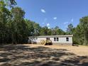 Side view of house with trees, gray siding, well maintained yard at 846 Lawyer Ln, Cross, SC 29436