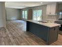 Modern kitchen featuring an island, stainless steel appliances, gray and white cabinets at 846 Lawyer Ln, Cross, SC 29436