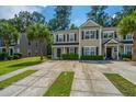 Attractive townhome with a well-maintained lawn, mature trees, and a paved walkway at 9098 Maple Grove Dr, Summerville, SC 29485