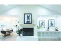 Stunning view of living room fireplace with open floor plan to dining area, and vaulted ceiling at 10 Bayshore Blvd, Goose Creek, SC 29445