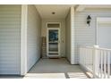 Welcoming covered front porch with a 'Home Sweet Home' sign and a view into the home at 1026 Briar Rose Ln, Ladson, SC 29456