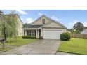 Charming single-story home with a manicured lawn and a two-car garage in a suburban neighborhood at 108 Larkspur Dr, Goose Creek, SC 29445