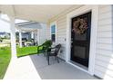 Inviting front porch with a charming wreath on the front door and comfortable chairs for relaxing at 112 Whisper Dr, Summerville, SC 29485