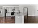 Modern kitchen with granite countertops, stainless steel appliances, gray cabinets, and hardwood floors at 113 Petrell Rd, Summerville, SC 29483