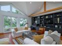Sun-drenched living area with a custom built-in shelving unit, and comfortable seating offering a view of the outdoors at 1195 Framptons Inlet Rd, Edisto Island, SC 29438