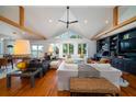 Open-concept living space with hardwood floors, high ceilings, custom shelving, and natural light from large windows at 1195 Framptons Inlet Rd, Edisto Island, SC 29438