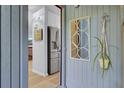 Welcoming foyer with stylish mirror and a glimpse of the modern kitchen beyond at 1208 Village Creek Ln Ln # 1, Mount Pleasant, SC 29464