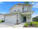 Two-story home featuring attached garage, manicured lawn, landscaping, and charming front porch with seating at 160 Brookhaven Rd, Summerville, SC 29486