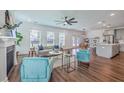 Open-concept living room with hardwood floors, fireplace, and abundant natural light at 175 Darby Meadow Ln, Ridgeville, SC 29472