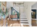 Bright foyer with elegant staircase, hardwood floors, and designer accents at 1828 S James Gregarie Rd, Mount Pleasant, SC 29466