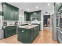 Modern kitchen with custom cabinets, stainless steel appliances, and center island with granite countertops at 1828 S James Gregarie Rd, Mount Pleasant, SC 29466