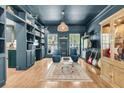 Stylish living room with built-in shelves, hardwood floors, and ample natural light at 1828 S James Gregarie Rd, Mount Pleasant, SC 29466