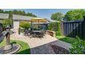 Private backyard featuring a patio area with outdoor dining set and mature landscaping at 1852 Pierce St, Charleston, SC 29492