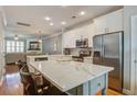 Modern kitchen featuring a large island with seating, stainless steel appliances, and hardwood floors at 1852 Pierce St, Charleston, SC 29492
