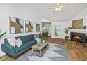 Bright living room boasts a fireplace, vaulted ceiling with fan, hardwood floors and an open floor plan at 1918 Piper Dr, Charleston, SC 29407