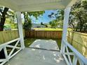 View from the porch of a fenced-in backyard featuring green grass and a concrete pad at 1991 Joppa Ave, North Charleston, SC 29405