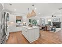 Open-concept kitchen with a central island, wooden floors, and modern appliances at 200 Bear Oak Ct, Moncks Corner, SC 29461