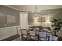 Inviting dining room with decorative wall art, a modern chandelier, and a plant at 260 Huguenot Trl, Huger, SC 29450