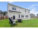 Cozy backyard with a patio, grill, fire pit, and chairs, perfect for outdoor relaxation at 277 Fiddleback Dr, Summerville, SC 29486