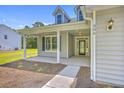 Inviting front porch with classic columns and a clear view of the front door and manicured landscaping at 306 Mizell Rd, Dorchester, SC 29437