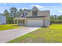 Lovely home featuring an attached two car garage and a spacious driveway in a well-kept neighborhood at 306 Mizell Rd, Dorchester, SC 29437