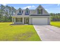 Inviting curb appeal with a well-maintained lawn and driveway leading to an attached two-car garage at 306 Mizell Rd, Dorchester, SC 29437