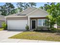 Attractive home exterior with a two-car garage, neat landscaping, and a welcoming front entrance at 309 Sedona Dr, Summerville, SC 29486