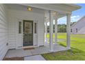 Inviting front porch with white columns, providing a welcoming entrance to the home at 310 Mizell Rd, Dorchester, SC 29437