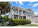 Charming two-story home with a double porch and a manicured lawn and palm tree at 346 Cicadas Song, Moncks Corner, SC 29461