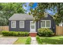 Cozy single-story home features a well-manicured lawn and charming front entryway at 3935 Walnut St, North Charleston, SC 29405