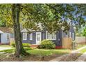 Quaint single-story home with a mature shade tree in the front yard at 3935 Walnut St, North Charleston, SC 29405