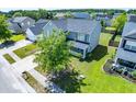 Aerial view of a lovely home with a spacious yard and beautiful landscaping at 414 Dovetail Cir, Summerville, SC 29483