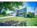 Inviting two-story home with a cozy front porch and well-kept lawn at 414 Dovetail Cir, Summerville, SC 29483