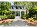 Charming two-story home with a inviting front porch and manicured landscaping at 5032 Coral Reef Dr, Johns Island, SC 29455