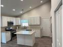 Bright kitchen featuring white cabinets, granite countertops, stainless steel appliances, and an island at 5445 Ansley Trl, North Charleston, SC 29418
