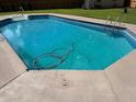 Refreshing in-ground pool with concrete surround, ready for summer fun and relaxation at 5445 Ansley Trl, North Charleston, SC 29418