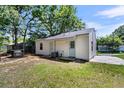 View of the back exterior of the house, showing the manicured back yard at 5806 Robinhood Dr, Hanahan, SC 29410