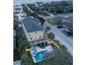 Aerial view of a home featuring a backyard pool, hot tub, deck, and outdoor seating at 601 Ocean Blvd, Isle of Palms, SC 29451