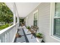 Spacious front porch featuring a charming bench, potted plants, and ample space for relaxation and enjoying the outdoors at 617 Willdrew Ln, Moncks Corner, SC 29461