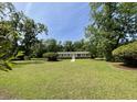Well-maintained single-story home surrounded by a lush green lawn and mature trees at 6287 Sniders Hwy, Walterboro, SC 29488
